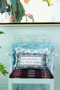 Nina Campbell Needlepoint Cushion First Rodeo on cushions on a chair