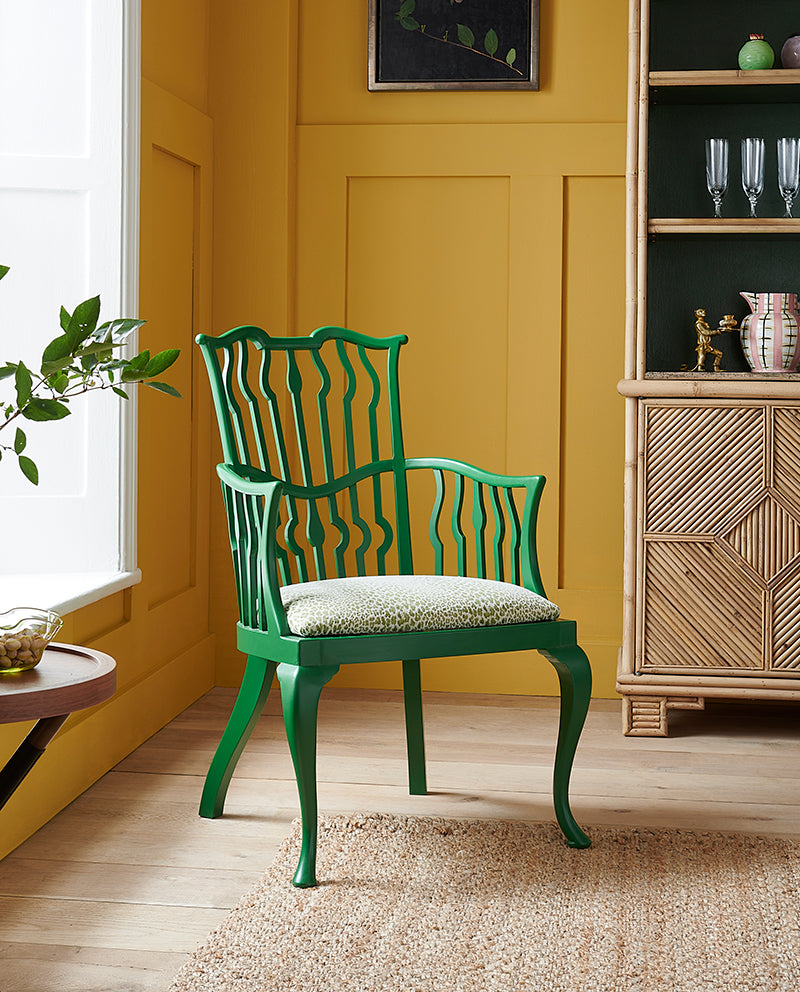 Nina Campbell Archie chair painted green in roomset with Alfred Bamboo Bookcase
