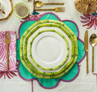 Nina Campbell Ceramic plate with hand painted bamboo design on edge in green in table setting