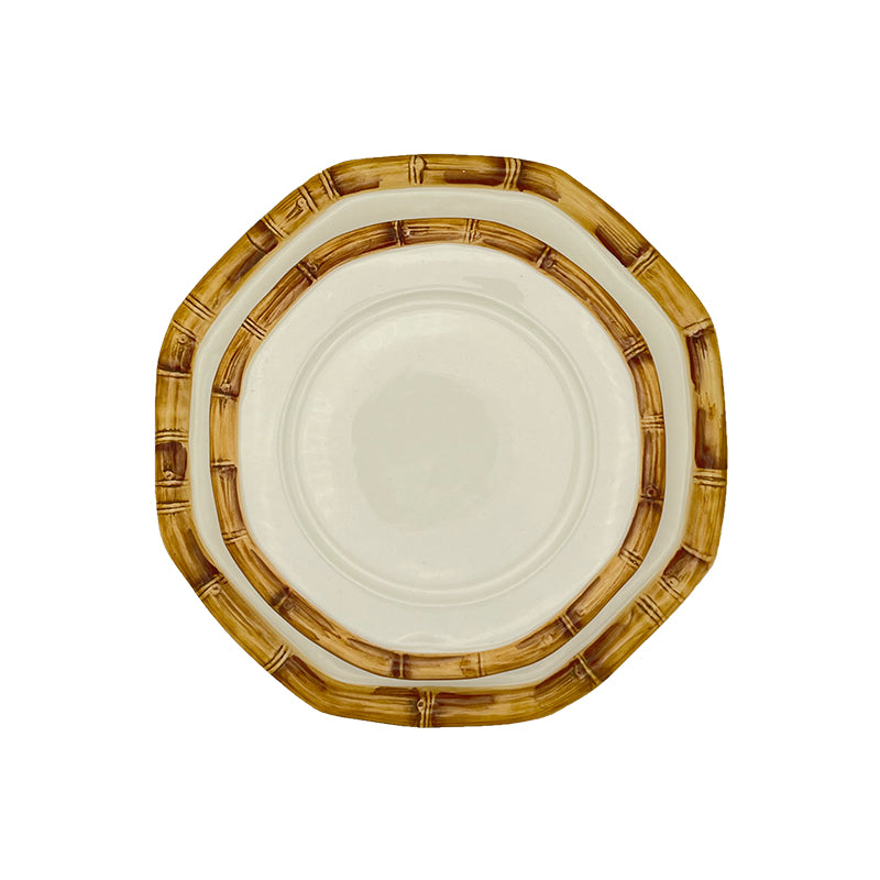 Nina Campbell stacked ceramic plates with hand painted bamboo design on edge in brown against white background