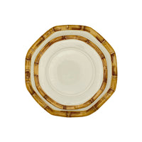 Nina Campbell stacked ceramic plates with hand painted bamboo design on edge in brown against white background