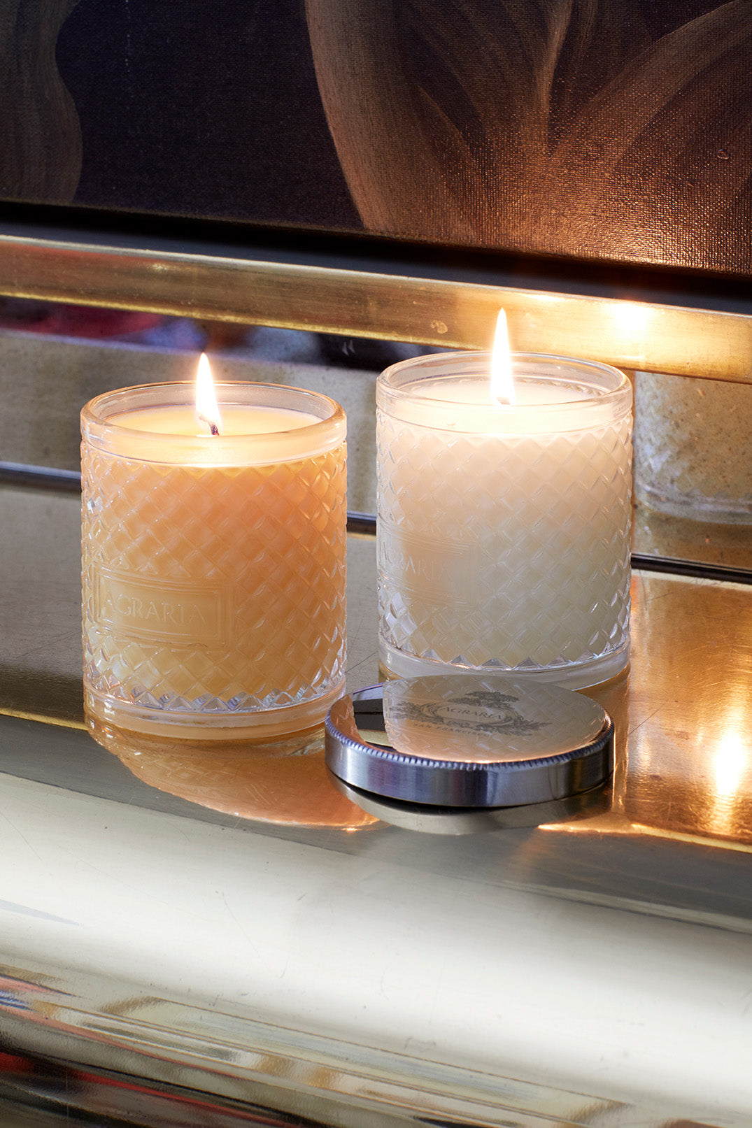 Image of 2 lit candles in glass jars