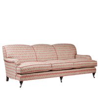 Nina Campbell Collingwood Sofa in dumas red and blue fabric against a white background angled shot