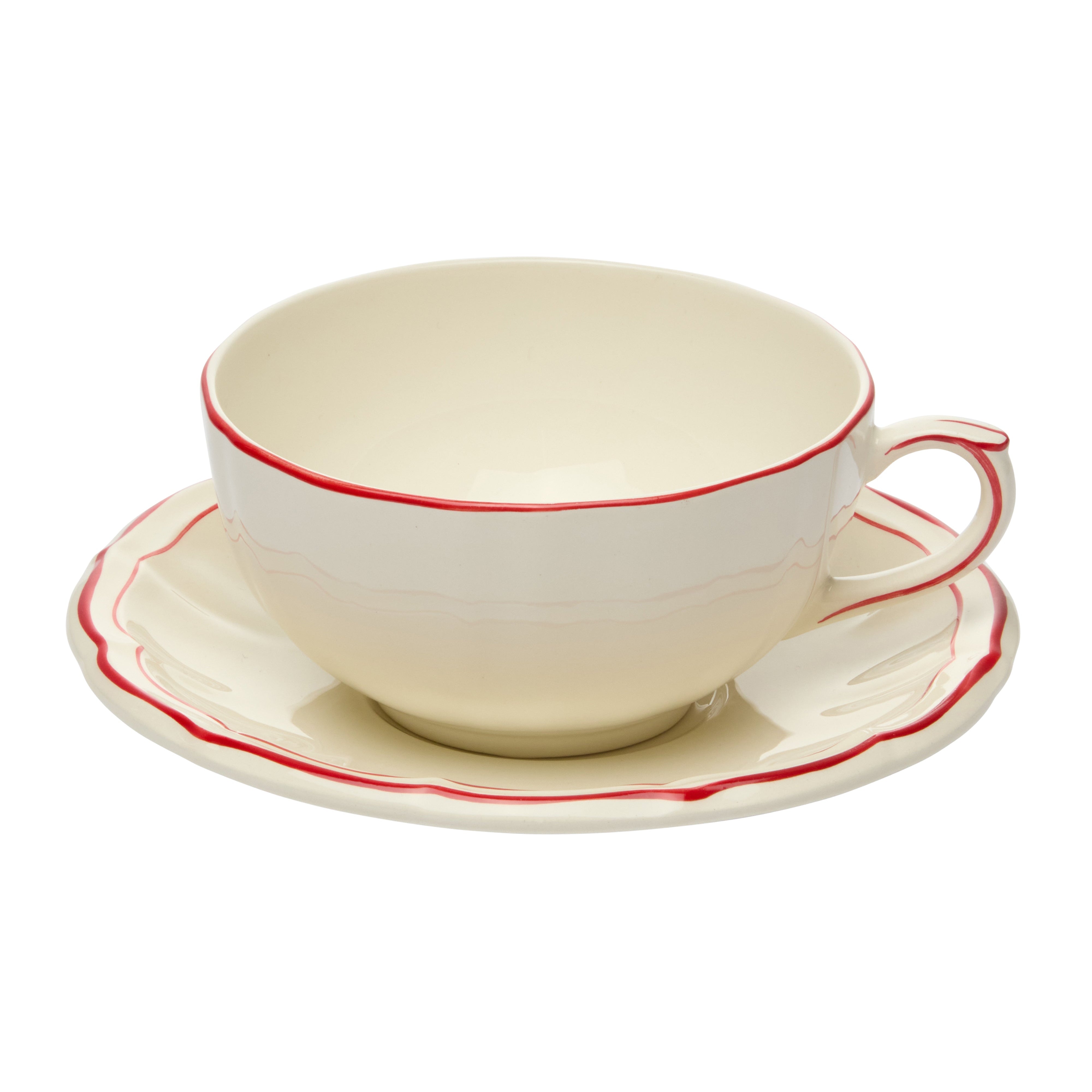 White teacup and saucer with red trim on a white background