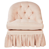 Nina Campbell pink fabric chair with frilled skirt against a white background