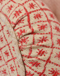Mabel Chair in Solitaire Coral fabric against a white background arm close up shot
