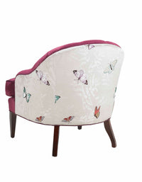Mabel Chair in pink velvet fabric and butterfly patterned fabric against a white background back shot