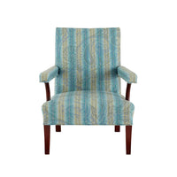 Nina Campbell Mackenzie Arm chair, in a striped blue and yellow fabric, on a white background.