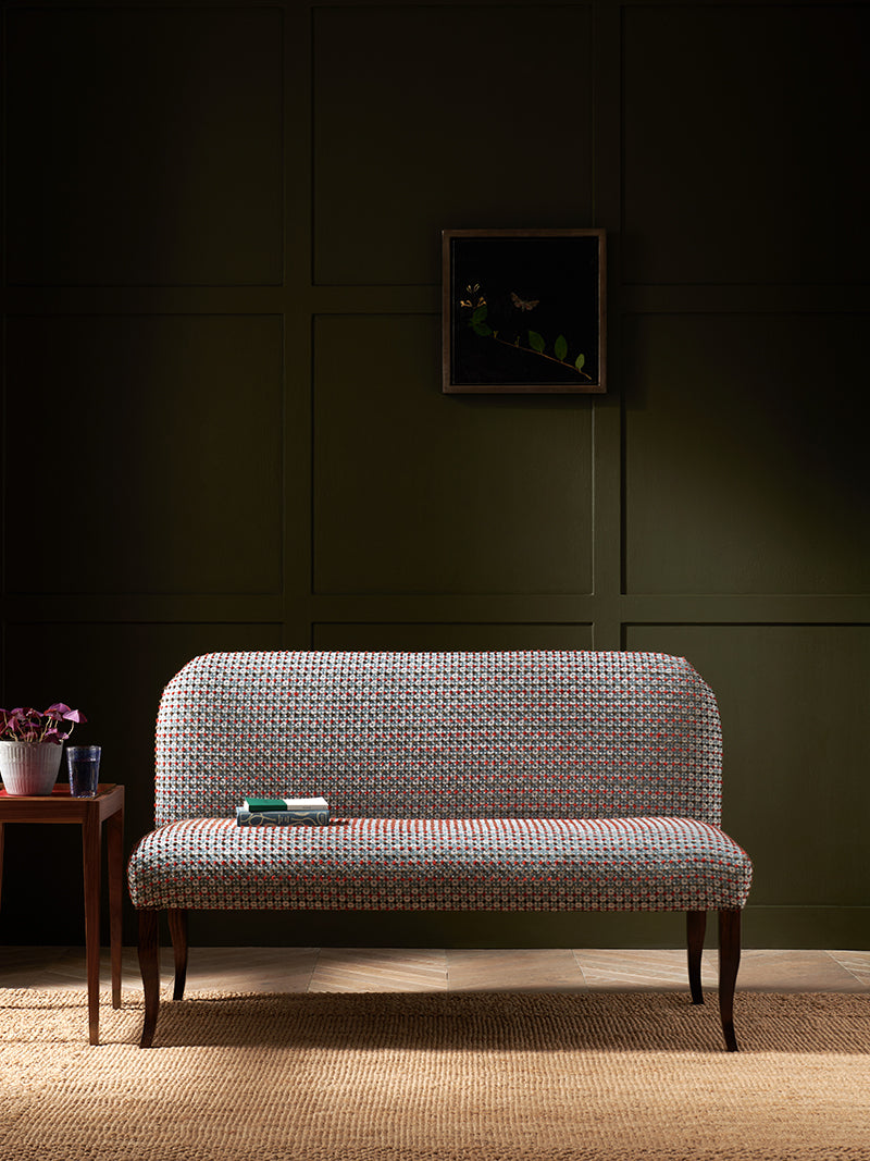 Nina Campbell Lehmann Bench in Chiddingstone Fabric in blue and red against in a room set with Sidney End Table