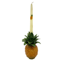 Nina Campbell ceramic hand painted pineapple candle holder with dinner candle on white background