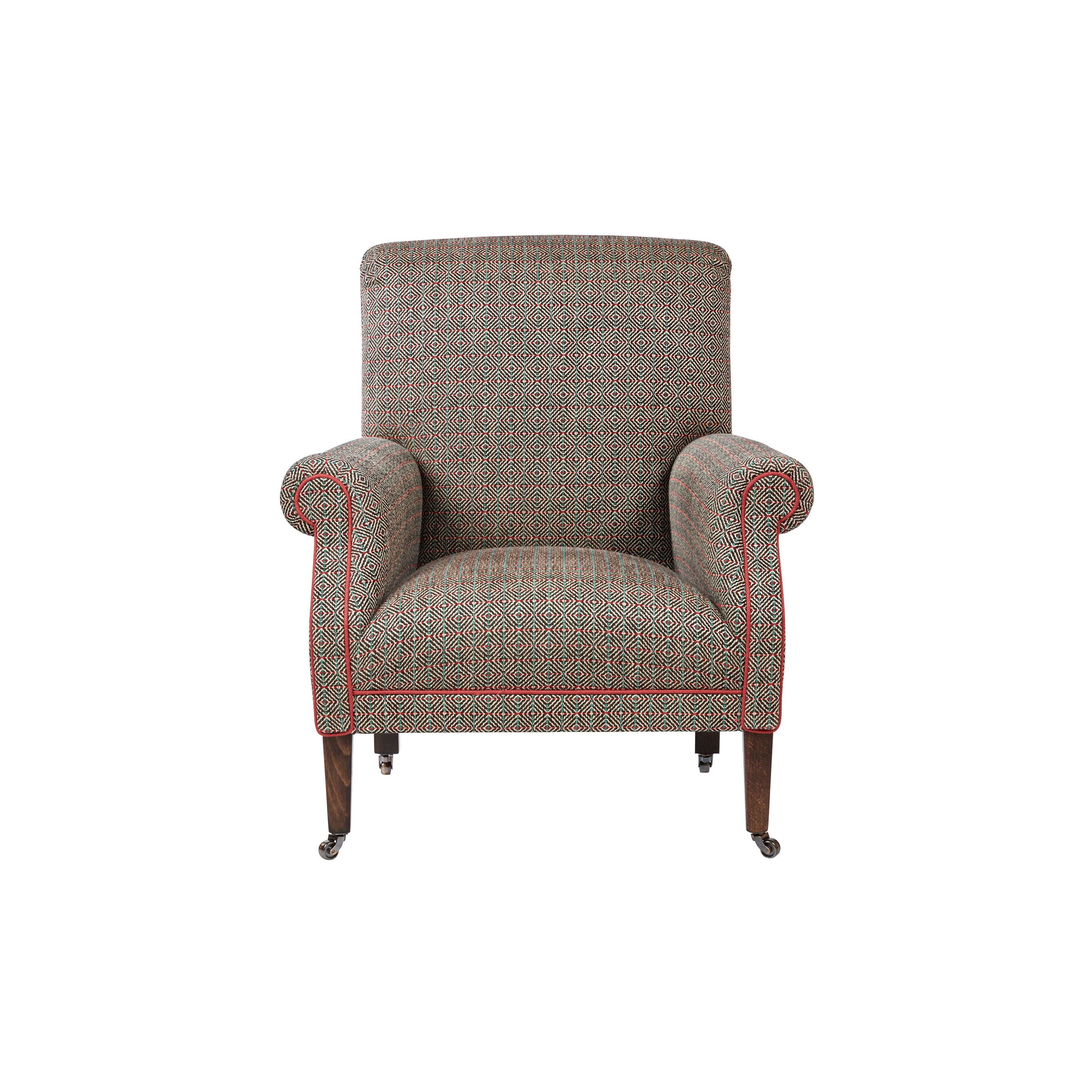 Nina Campbell Robert Browning Armchair, in a brown fabric with red piping, on a white background.