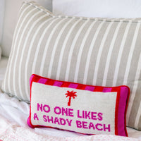 Nina Campbell Needlepoint Cushion Shady Beach  against a couch