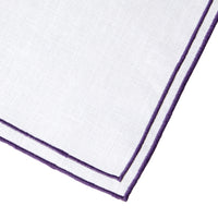 Nina Campbell Linen Napkin White/Aubergine against a white background close up