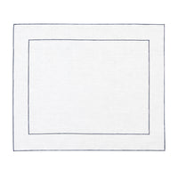 Nina Campbell Coated Linen Placemat Framed Navy against a white background