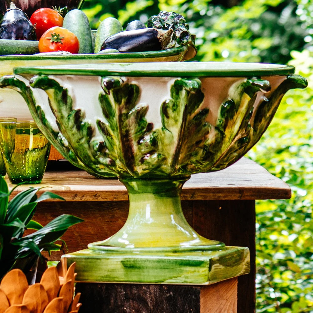 Nina Campbell ceramic leafy footed bowl in green on a table outside