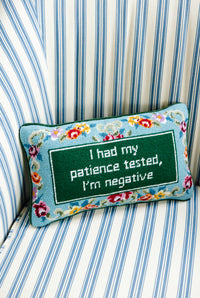 Nina Campbell Needlepoint Cushion Patience against a couch