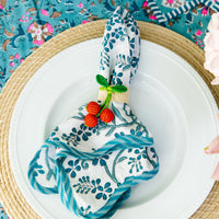 Nina Campbell Raffia Napkin Ring Cherry  on blue napkin