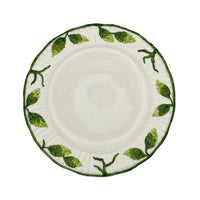 Nina Campbell white ceramic plate with green leaf design around the edge against a white background