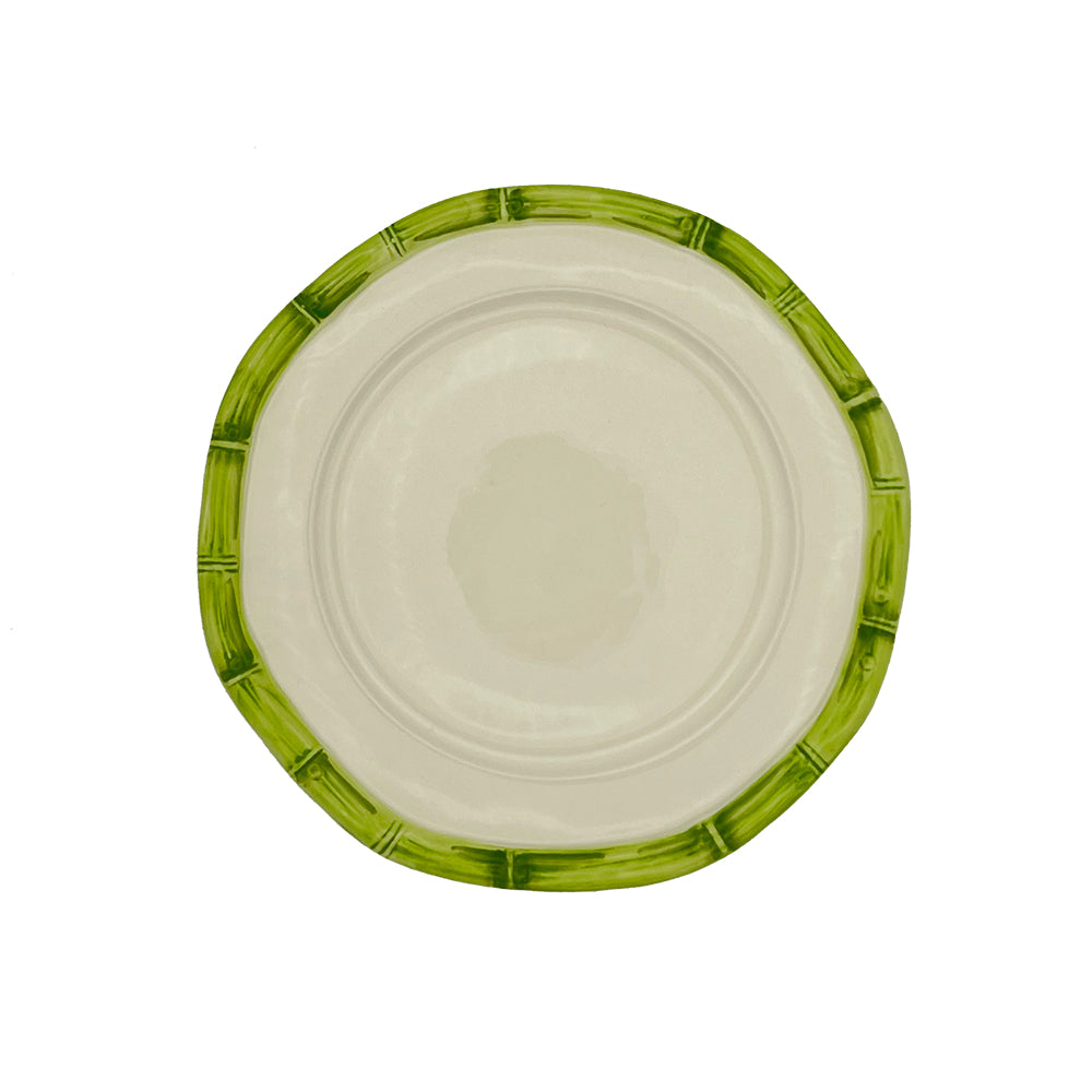 Nina Campbell white ceramic plate with painted green bamboo design on edge against white background