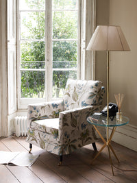 Nina Campbell Arthur Lamp Table in Polished Brass in a room setting