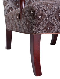  Nina Campbell Mackenzie Arm chair, in a brown fabric, on a white background. Zoomed in image of the wooden chair legs.