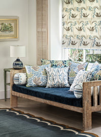 Nina Campbell Athena Fabric seen on cushions and blind, and gabrielle fabric on sofa cushion in a living room setting