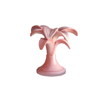 Nina Campbell ceramic small palm candlestick holder painted in pink against a white background