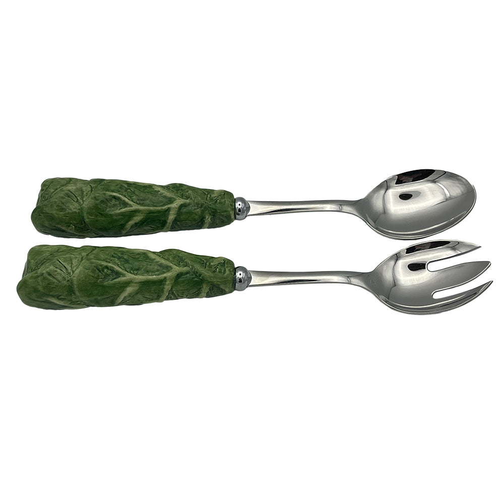 Nina Campbell Stainless steel serving set with ceramic handles resembling leaves and hand painted in green on a white background