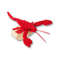 Nina Campbell Raffia Napkin Ring Red Lobster against a white background