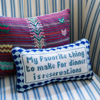 Nina Campbell Needlepoint Cushion Reservations against pillow and couch