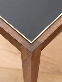 Nina Campbell Sidney End Table in Black Leather against a white background close up corner