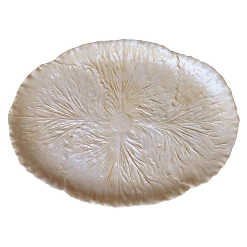 Nina Campbell oval ceramic serving platter painted in cream on a white background