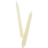 Cream candles on white background 