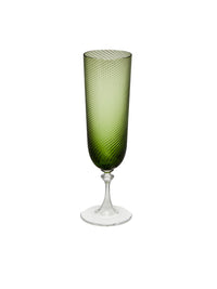 Nina Campbell green champagne glass against a white background